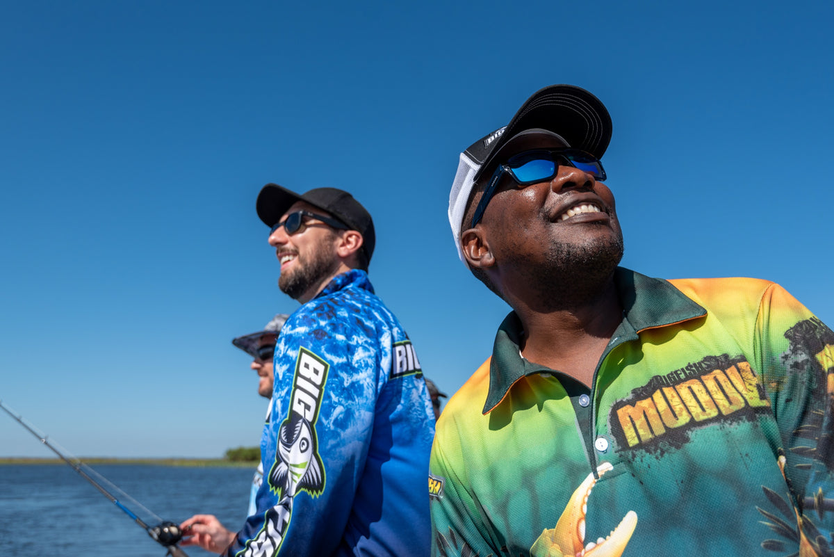 Two anglers laughing on a boat in Bigfish fishing shirts
