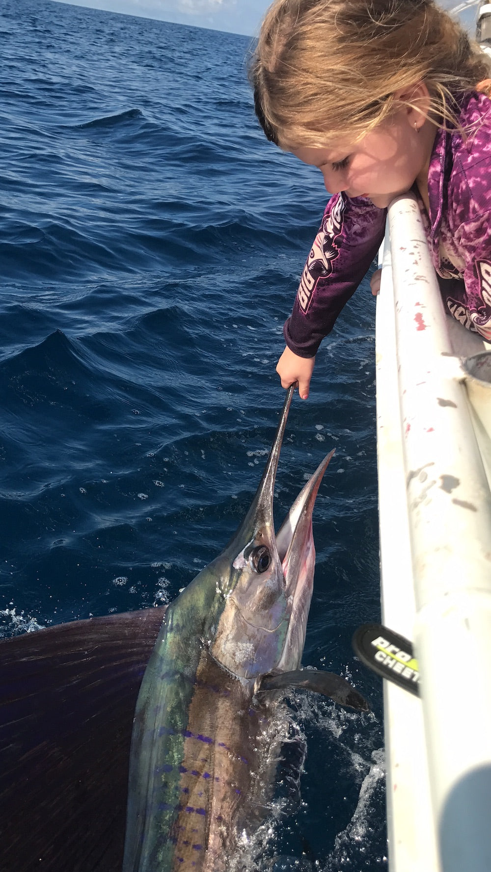Purple Scales lifestyle - young angler with marlin