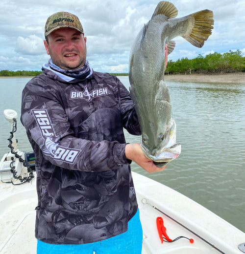Angler with Barramundi wearing Aus Camo Dark Grey Hoodie