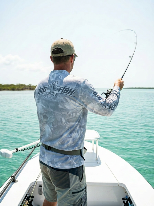 Angler casting from flats boat wearing Aus Camo Light Grey