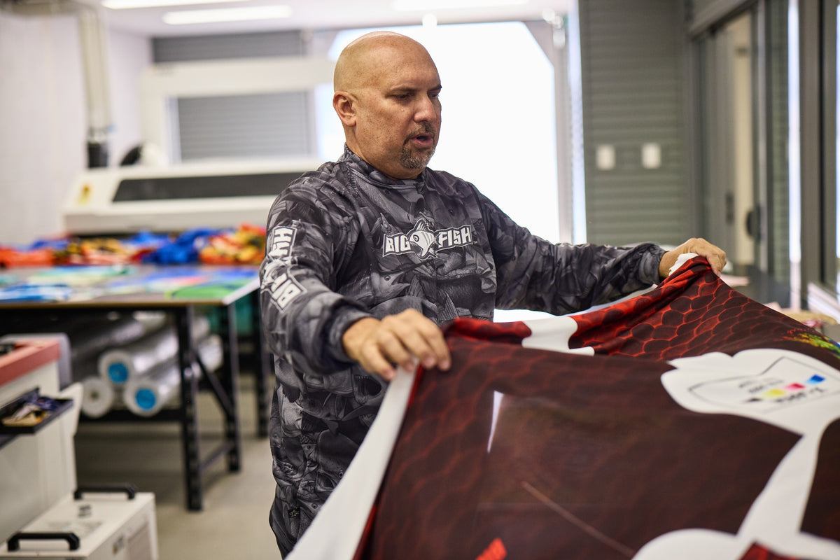 Hands-on quality inspection of a freshly printed custom shirt